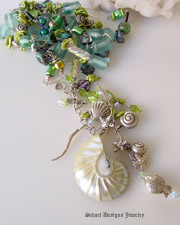   Necklace | 64 inch long stunning combination of treasures from the beach. The vintage aqua sea glass, lampwork beads, abalone, pearls, dichroic glass, and swarovski crystal are unexpected partners and hand linked with silver wire and of course the wonderful sealife charms and pearly white nautilus shell 
