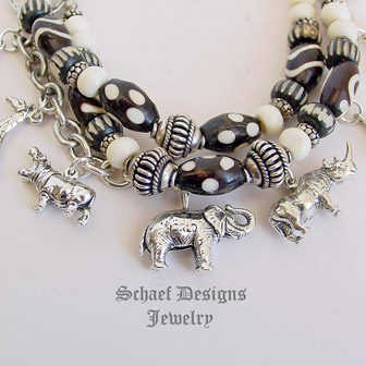  Schaef Designs black & white trade bead & sterling silver endangered species african animals 3 strand white coral charm bracelet | New Mexico