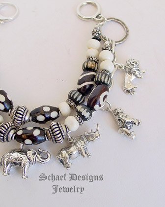  Schaef Designs black & white trade bead & sterling silver endangered species african animals 3 strand white coral charm bracelet | New Mexico